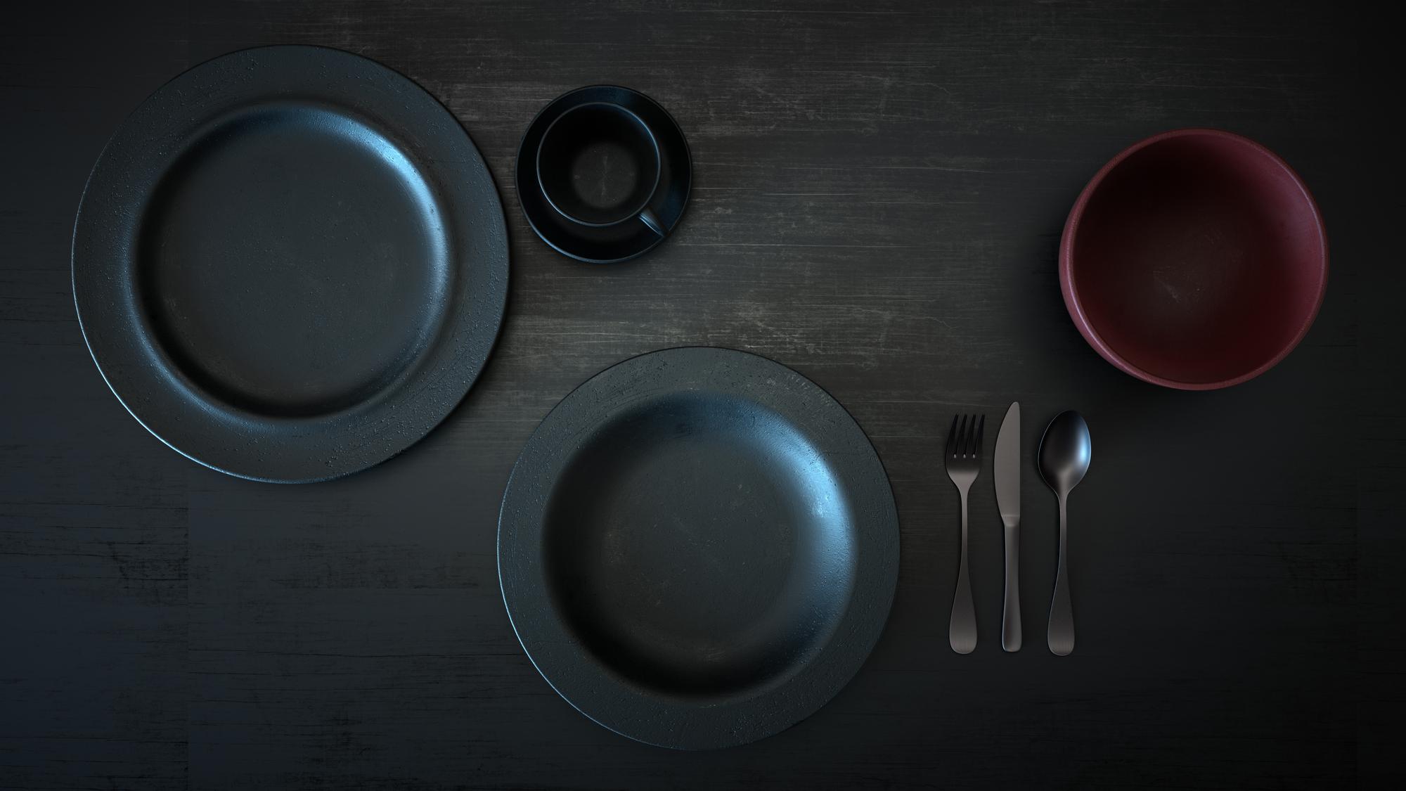 Set of plated dishes on dark table